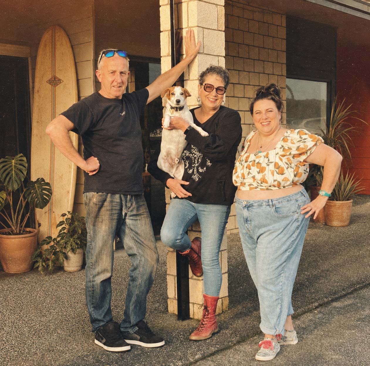 Smith-and-Local-Owners-Outside-the-Cafe-in-Parua-Bay Helen, Fish and Regan outside Smith and Local cafe in Parua Bay with their dog, celebrating the cafe’s past and present in a warm coastal setting.