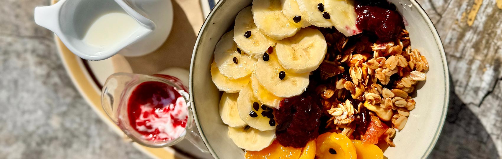 Menu at Smith and Local looking down on a breakfast item with bananas and fruit and granola